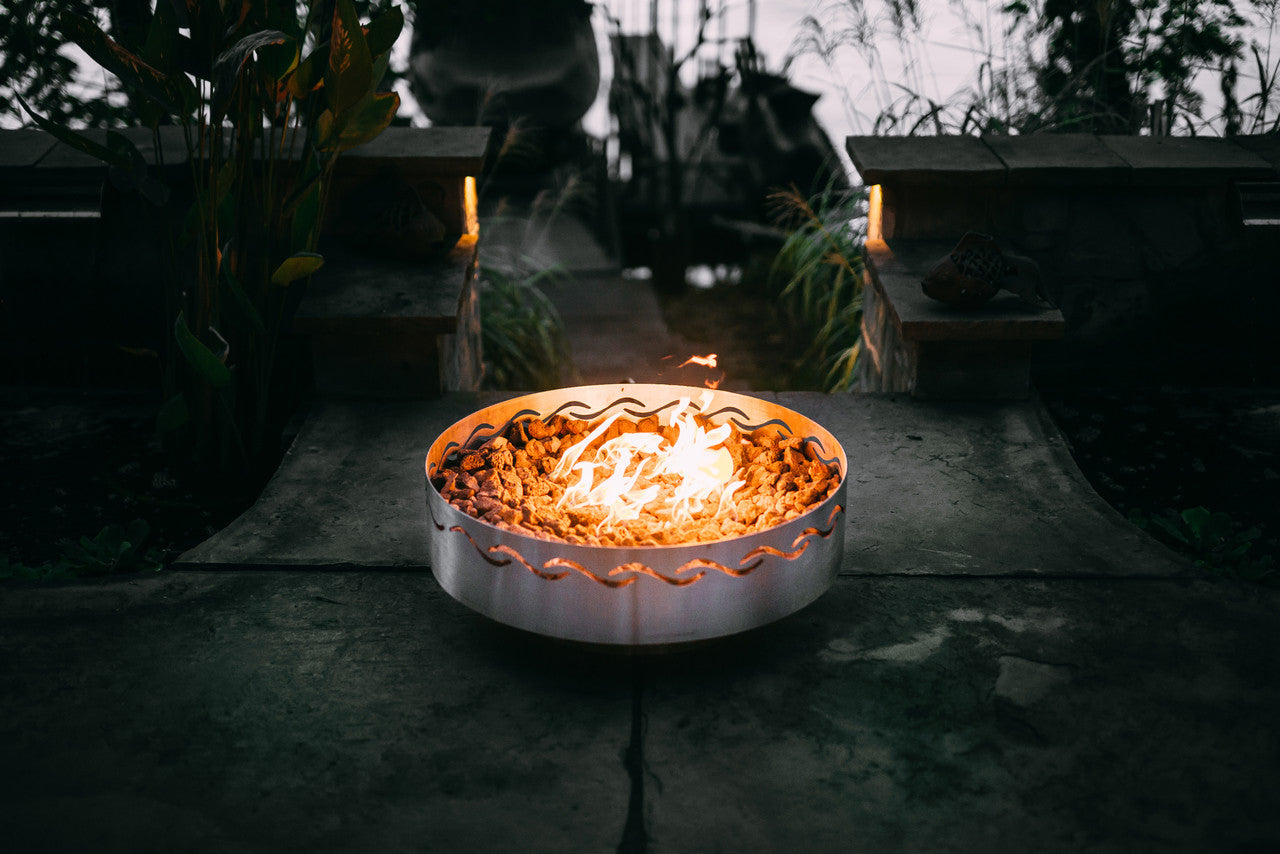 Fire pit with flames in a dark outdoor setting