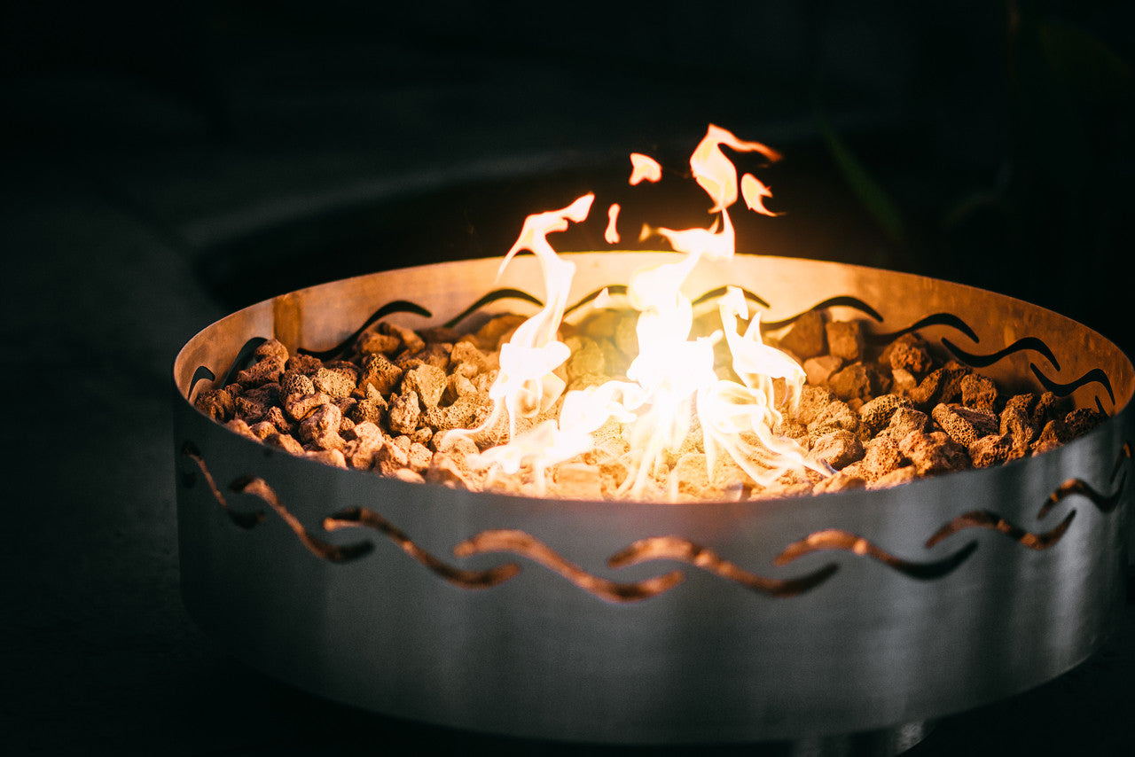 Fire pit with flames burning against a dark background