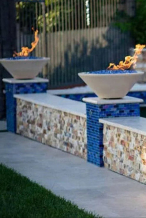 Two fire pits with flames on a stone patio