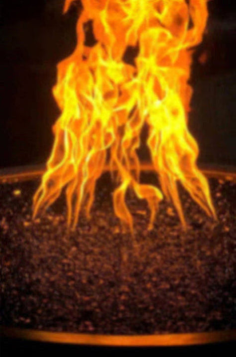 Close-up of flames burning in a container with dark pebbles.