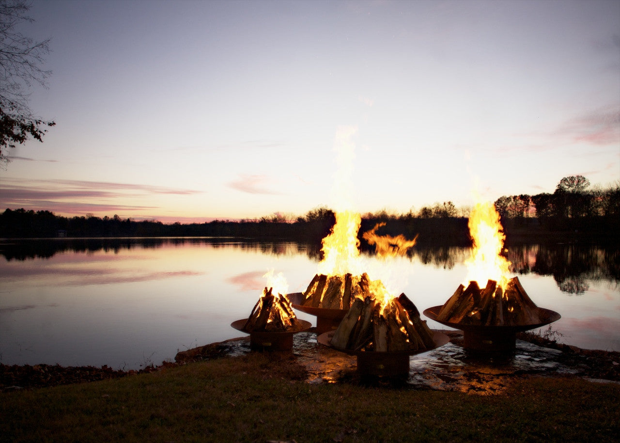 Fire pits by a lake at sunset