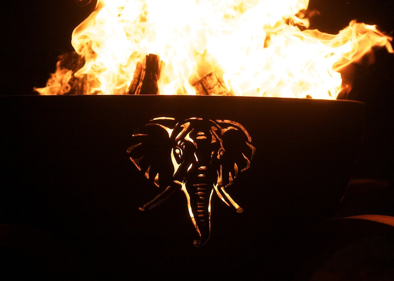 Fire pit with an elephant design in front of flames