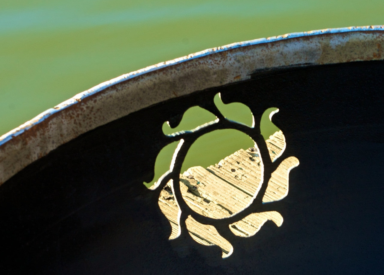 Decorative metal design with a leaf pattern on a dark background