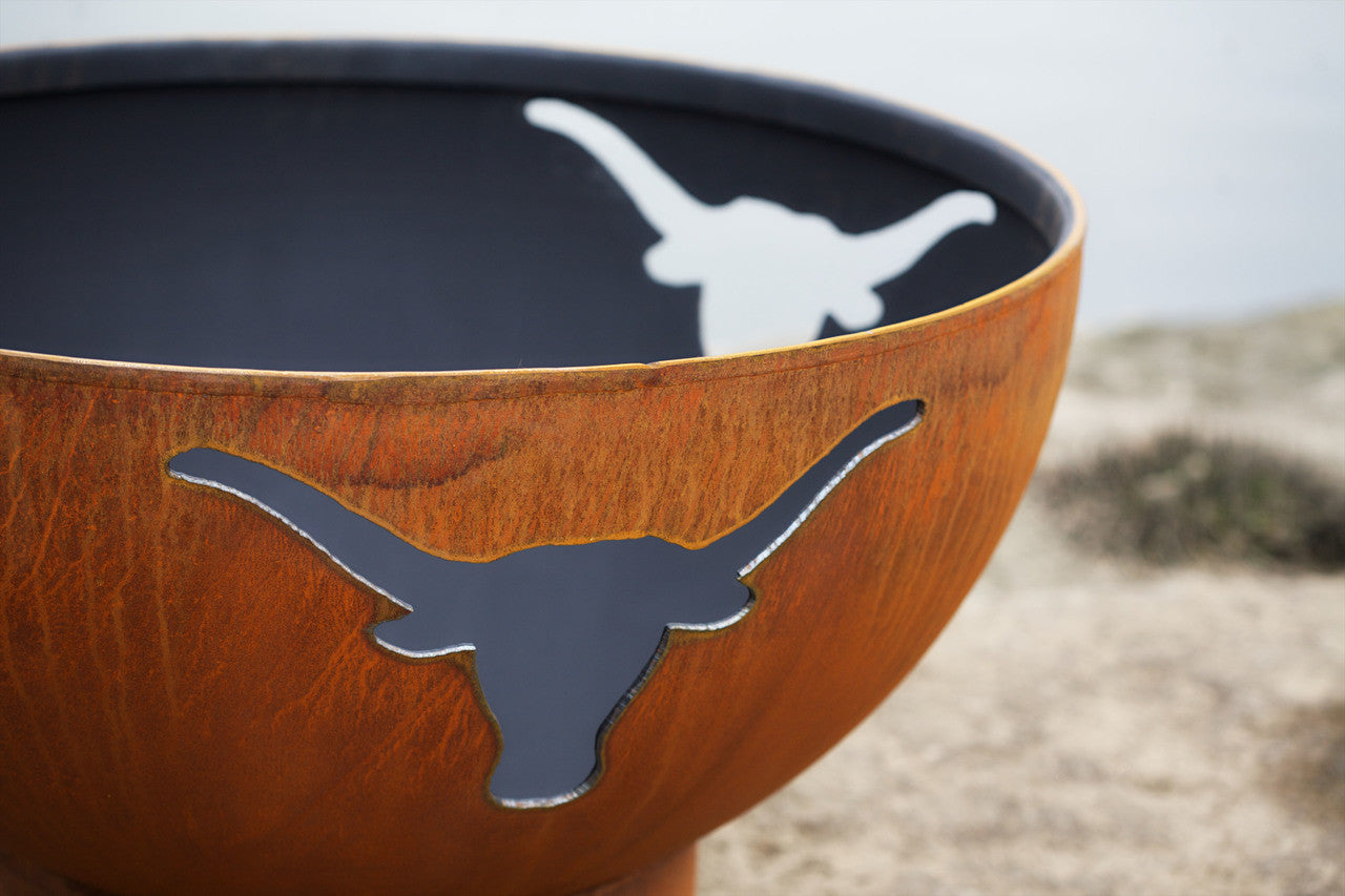 Metal bowl with a longhorn design on a blurred natural background