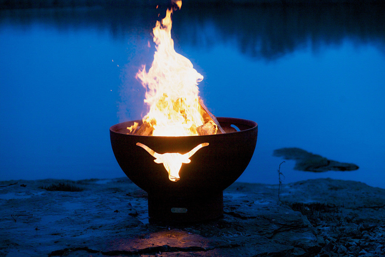 Fire pit with flames glowing in a dark outdoor setting