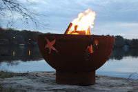 Fire pit with starfish design by a lake at dusk