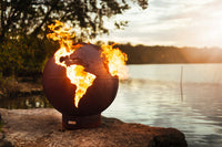 Magnificent Artist sculpture of large fire pit bowl with flames burning inside that is desired throughout the world