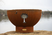 Artist metal fire pit with beautiful palmetto design on a lake background